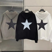 Men's star print long sleeve hoodies in gray, black, and white hanging on a rack.