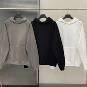 Men's star print long sleeve hoodies in gray, black, and white on hangers.