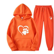 Dog print hoodie and pants set in orange with heart and paw design.